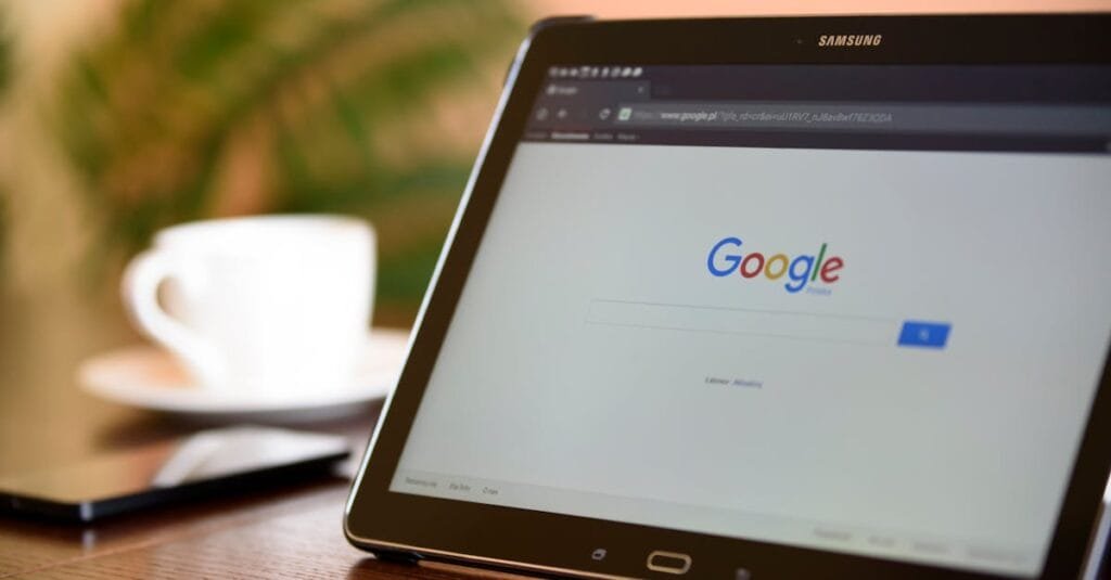 Samsung tablet on desk showing Google homepage, perfect for technology-related content.