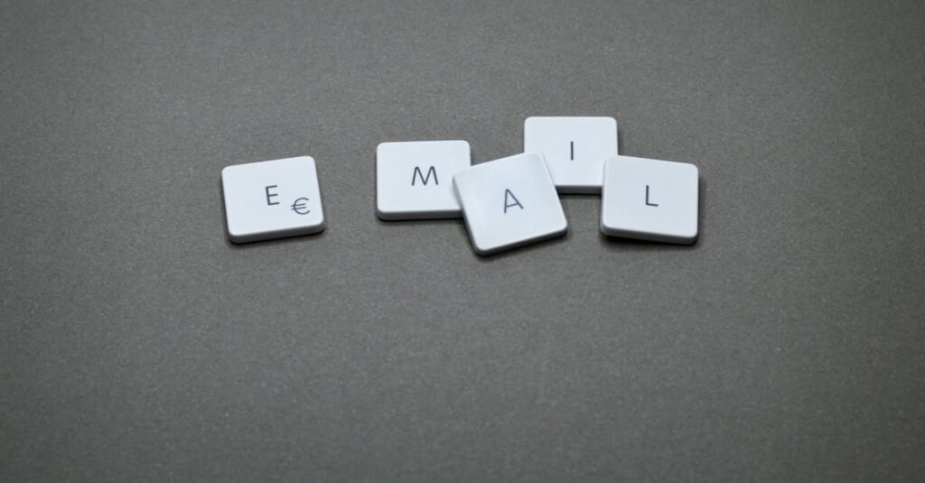 10 Tips Email Marketing untuk Meningkatkan Jualan 3 Close-up of the word 'email' formed with letter tiles on a gray surface.