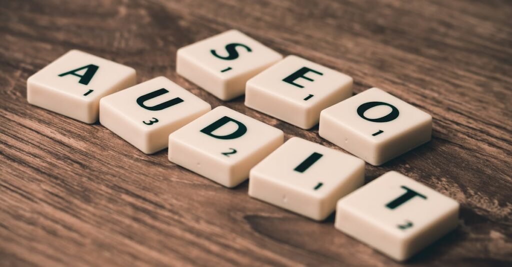 7 Tips Local SEO Malaysia untuk Perniagaan Tempatan 10 Scrabble tiles spelling SEO Audit on wooden surface, symbolizing digital marketing strategies.